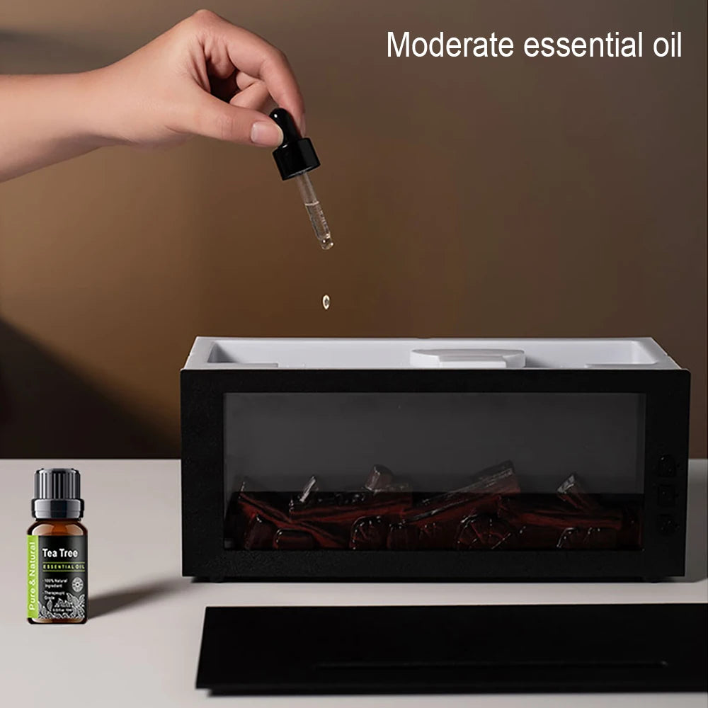 Hand dropping essential oil into a diffuser with a bottle of tea tree oil on a neutral background