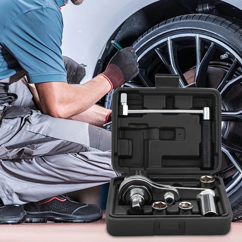 Mechanic working on a car tire with a tool set in the foreground