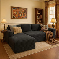 Living room with a dark gray sectional sofa, decorative pillows, and a lamp.